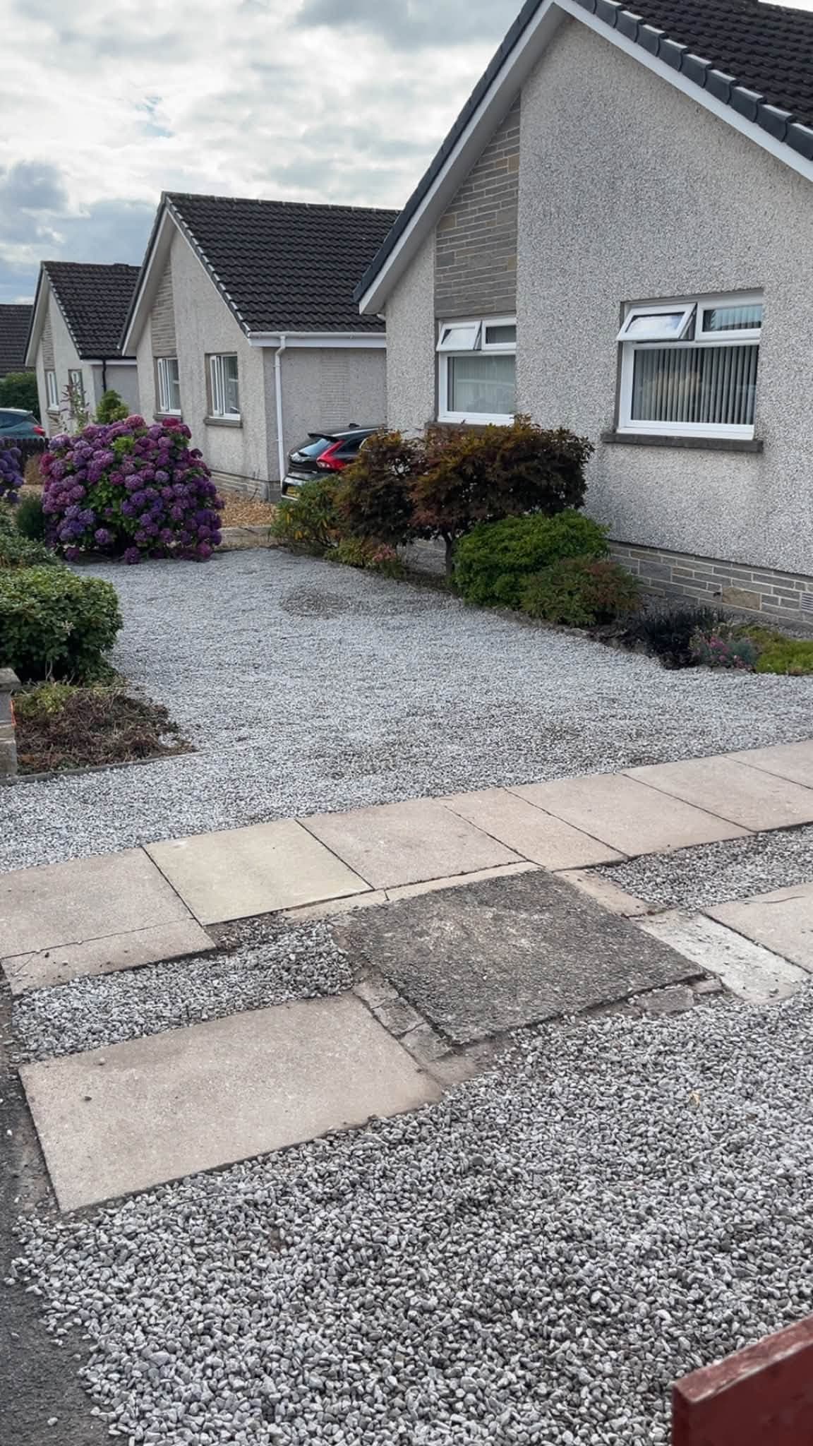 Landscaped garden with decorative stone and paving completed by RML Ground Maintenance in Portpatrick