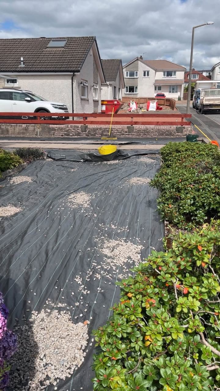 Weed membrane being laid during a garden landscaping project in Portpatrick