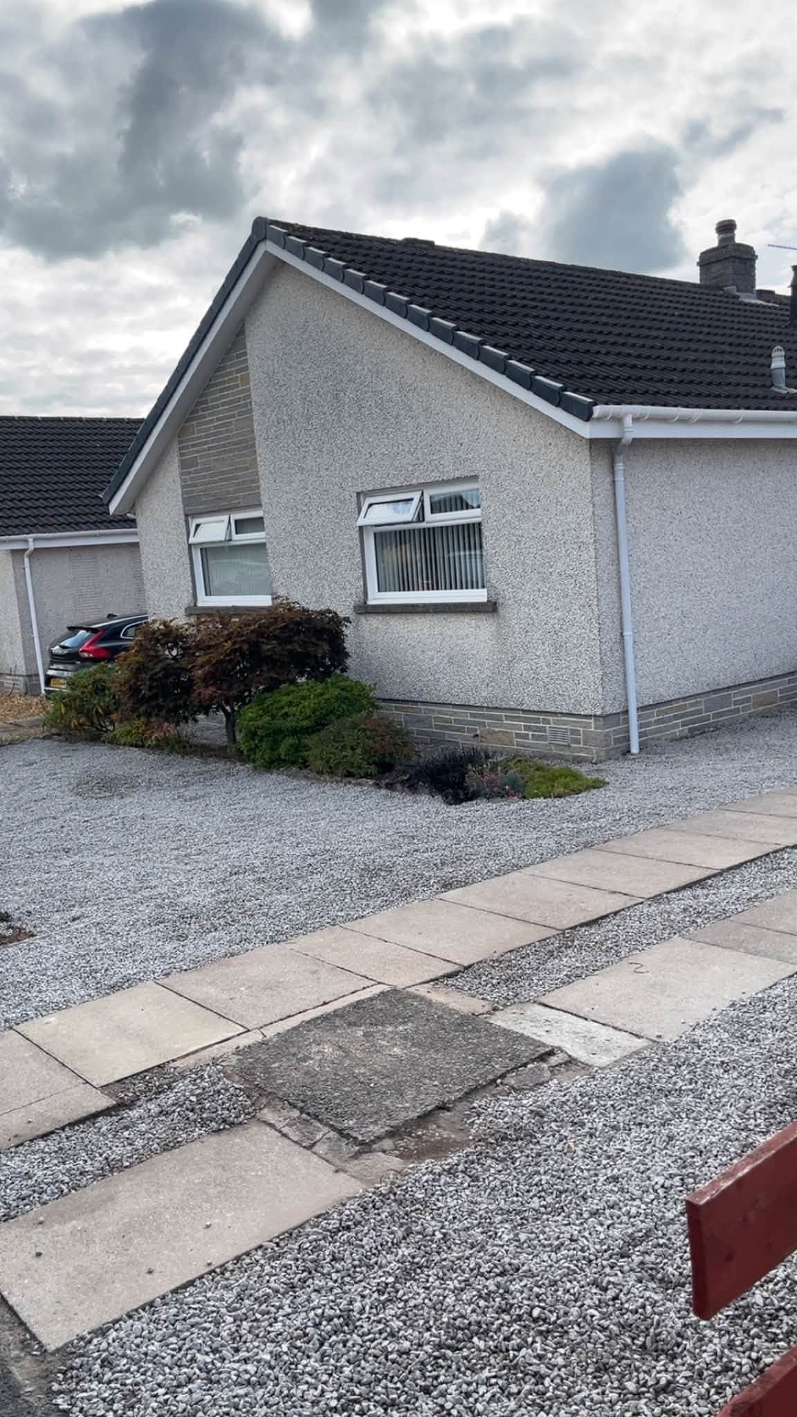 Completed garden landscaping with new gravel and tidy borders